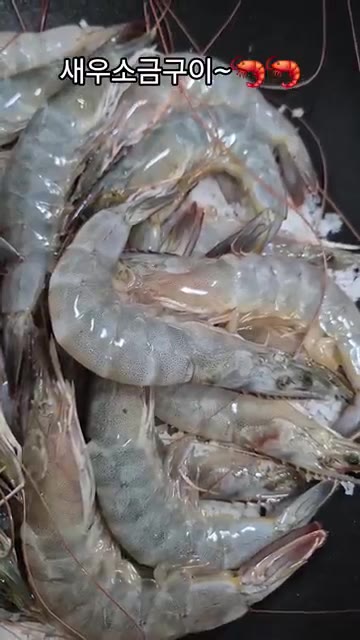 팬에 굵은 소금을 깔고 새우를 올린다. — 새우 소금구이