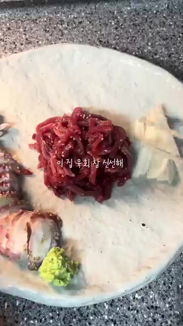 접시에 육회를 담고 참깨를 뿌린다. 산낙지를 곁들인다. — 야식으로 즐기는 육회와 닭발, 그리고 케이크