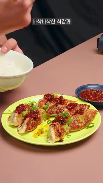 구워진 만두 위에 고추기름과 양념장을 올려 완성한다. — 너무 간편한데 너무 맛있다 집 만두로 교자밥 만들기